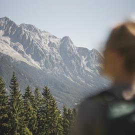 A woman is enjoying the mountain panorama in summer